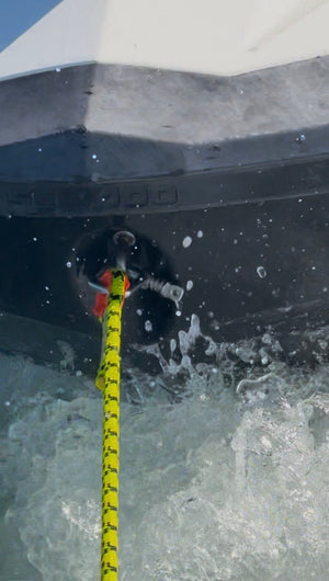 Close-up of a Snap-D stainless steel D shackle securing a Sea-Doo jet ski during towing on the water.